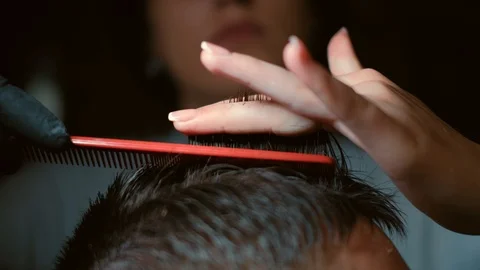 Barber cuts the hair of the client with scissors close-up. Frame. Barber combing Stock Footage 120265853
