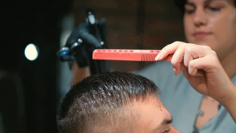 Barber cuts the hair of the client with scissors close-up. Frame. Barber combing Stock Footage 120266154