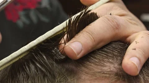 Barber cuts the hair of the client with scissors 4k Stock Footage 156957292
