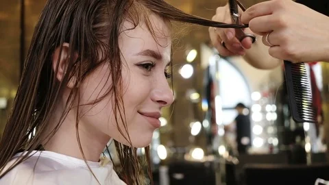 Barber cuts hair with scissors Stock Footage 73982276