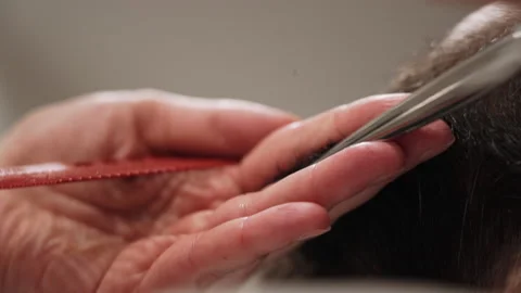 Barber cuts a man's beard with scissors Stock Footage 157621567
