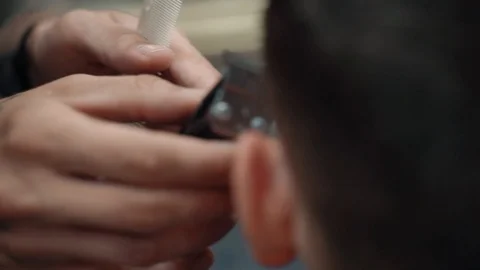 Barber cuts the man's temple Stock Footage 116814094