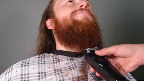 Barber cuts red beard Stock Footage 247088165