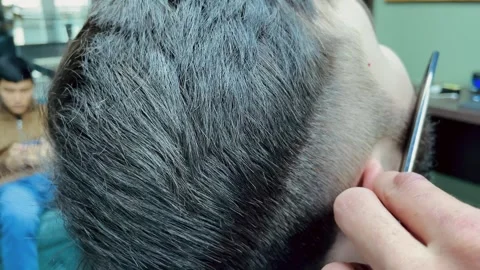 Barber cutting beard using electric trimmer, barber makes haircut for groom Stock Footage 241023414