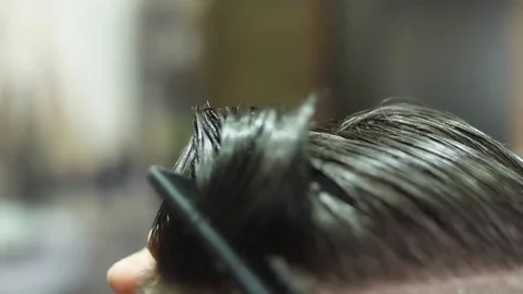 Barber cutting client hair with scissors slow motion Stock Footage 82724091