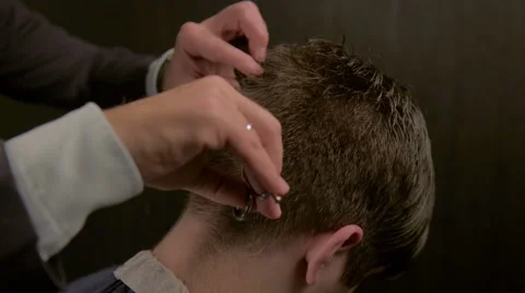Barber cutting hair with scissors Stock Footage 56002618