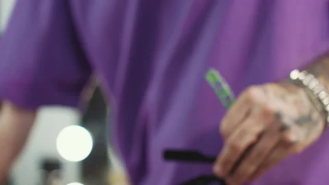 Barber disinfects cutting tools Stock Footage 239130656