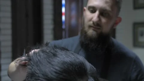 Barber does the styling to a man Stock Footage 88223833