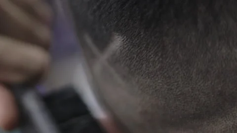 Barber draws an X on client with clippers Stock Footage 147460080