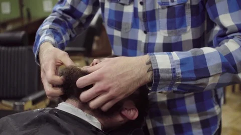 Barber is drying beard a bearded man with hairdryer in a barber shop Stock Footage 69987131