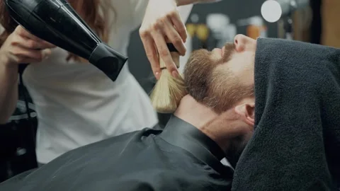 Barber Drying Client Beard In Barbershop 스톡 동영상 339183023