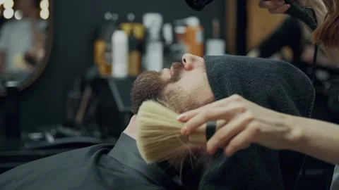 Barber Drying Client Beard In Barbershop Vídeo Stock 339665105