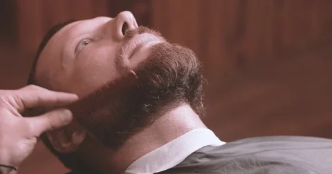 Barber hand cutting beard with clipper at barbershop 4k close-up video Stock Footage 68378837