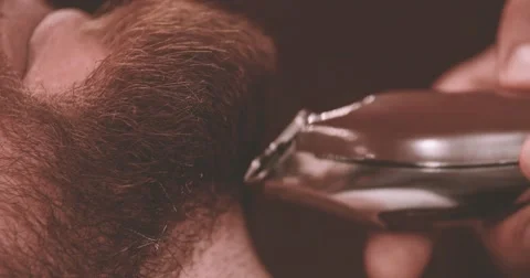 Barber hand cutting beard with clipper barbershop 4k close-up video Stock Footage 68379016