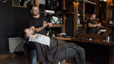 Barber heating razor before shaving Stock-Footage 127176625