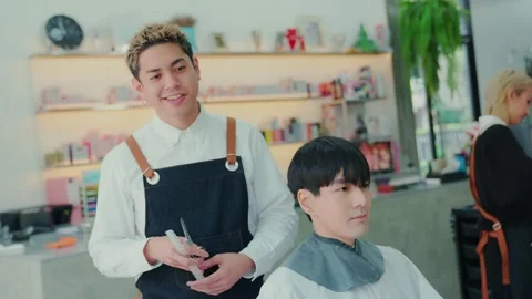 A barber holding scissors and a comb equipment of hairdressing device. he smi Stock Footage 153965429