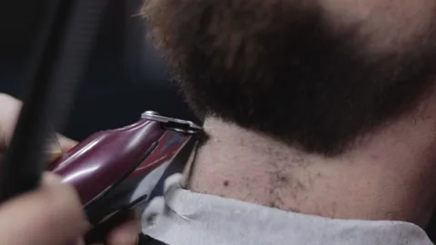 Barber lines beard with clippers Stock Footage 147452485