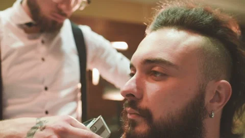 Barber makes the cut or styling of a beard Stock-Footage 100637572