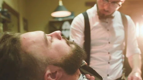 Barber makes the cut or styling of a beard Stock-Footage 100637770