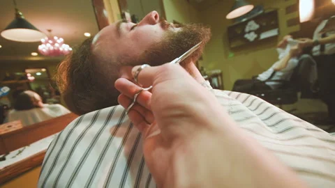 Barber makes the cut or styling of a beard Stock-Footage 100637996