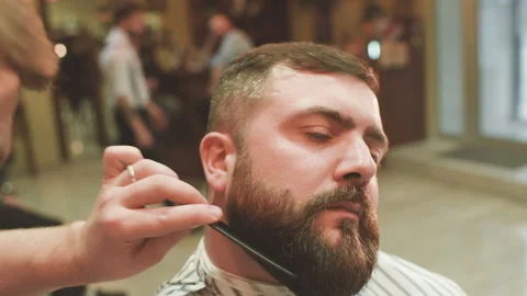 Barber makes the cut or styling of a beard Stock-Footage 101430008