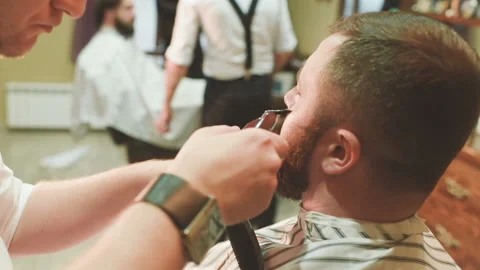 Barber makes the cut or styling of a beard Video stock 102800037