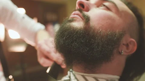 Barber makes the cut or styling of a beard Stock-Footage 103457082