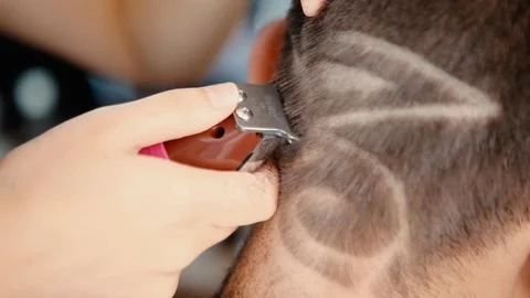 Barber makes cut shapes with a clipper in professional hairdressing salon Stock Footage