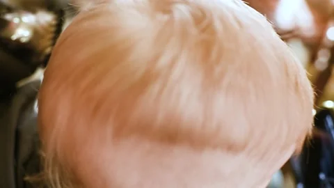 Barber makes the first haircut for a one-year-old child in a modern barbershop Stock-Footage 168564290