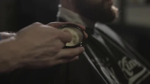 Barber makes hairstyle using styling gel.Barbershop. Video stock 72631922
