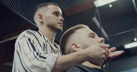Barber master arranges a client's beard, bearded man, massages of the face. Stock Footage 139624472