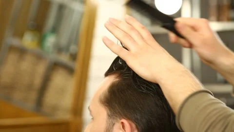 Barber master combing and modelling hair of client Stock Footage 91215670