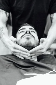 Barber master prepares face of client for shaving Stock Photos