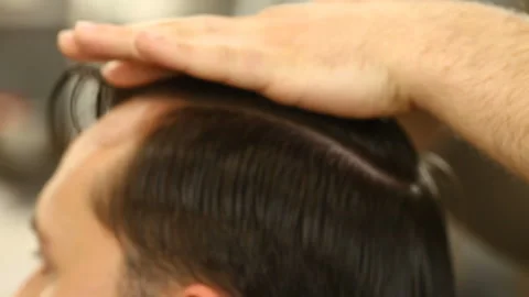Barber master smooths and combs hair of client Stock Footage 91215565