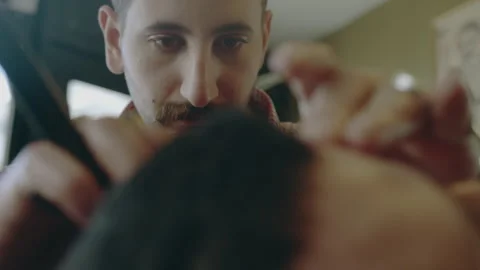 A Barber performing fine trimming Stock Footage 275024666