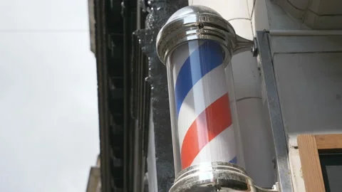 A barber pole rotating on a wall. Stock Footage 138560983