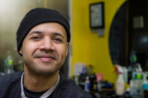 Barber posing in his shop. Stock Photos