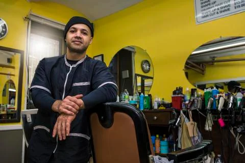 Barber posing in his shop. Stock Photos