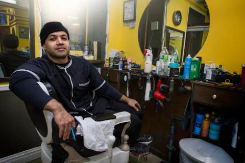 Barber posing in his shop. Stock Photos