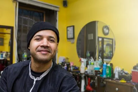 Barber posing in his shop. Stock Photos