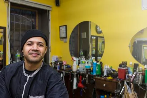 Barber posing in his shop. Stock Photos