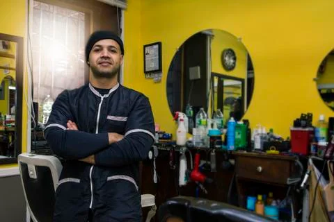Barber posing in his shop. Stock Photos