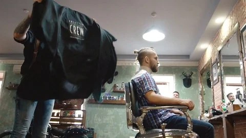 Barber prepares the client for a haircut. Stock Footage 86685055