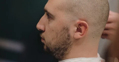 Barber prepares the client for shaving, bald haircutting Stock Footage 91386158
