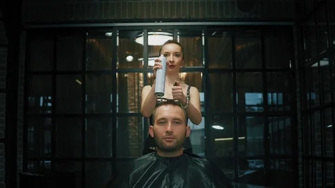 The barber prepares to cut a man with fire and lights a fire over his head Stock Footage 101739132