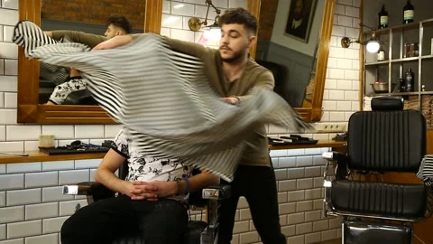 Barber preparing client for haircut Stock Footage 91216055