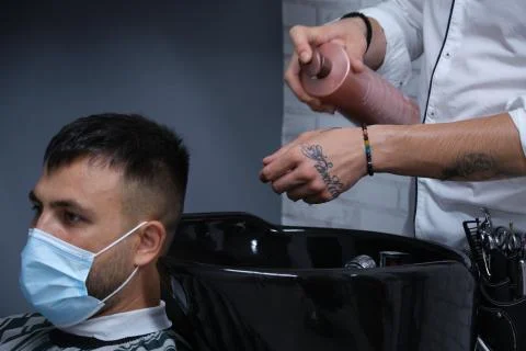 Barber putting shampoo on client Stock Photos