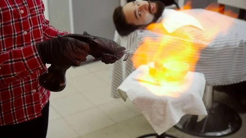 Barber razor ignites the flame of fire. Slow motion Stock Footage 70727453