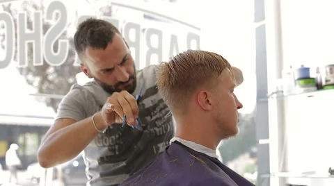 Barber scissors cuts the hair of the client Stock Footage 68319691