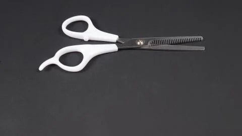 Barber scissors isolated on black background. Stockfoto's